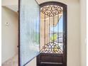 Elegant entryway with an ornate wrought iron door and decorative tile flooring at 12 E Foothill Dr, Phoenix, AZ 85020