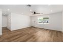 Bright living room featuring wood flooring, a ceiling fan, and a large window at 1308 N 71St St, Scottsdale, AZ 85257