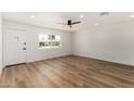 Bright living room featuring wood flooring, a ceiling fan, and a front door at 1308 N 71St St, Scottsdale, AZ 85257