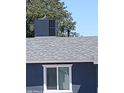 A roof with a modern HVAC unit and a white-trimmed window at 13629 N 36Th St, Phoenix, AZ 85032