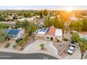 Aerial view of property showcasing a pool, desert landscaping, solar panels and mountain views at 16436 N 64Th Pl, Scottsdale, AZ 85254
