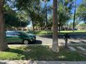 Scenic street view showcases lush trees and the home across the street, conveying a tranquil atmosphere at 21166 W Main St, Buckeye, AZ 85396