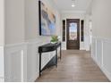 Inviting entryway featuring decorative front door, stylish console table and eye-catching artwork at 2546 E Russell St, Mesa, AZ 85213