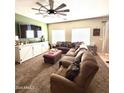 Comfortable living room featuring a large sectional sofa and a modern ceiling fan at 2635 E Riviera Dr, Chandler, AZ 85249
