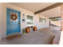 Welcoming front porch features a vibrant blue door and ample space for decor at 2902 E Corrine Dr, Phoenix, AZ 85032