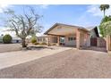 Inviting single-story home featuring a wide covered carport and desert landscaping at 2902 E Corrine Dr, Phoenix, AZ 85032