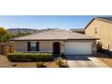 Charming single-story home featuring a two-car garage, desert landscaping, and a beautiful mountain view at 3319 W Carter Rd, Phoenix, AZ 85041