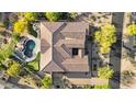 Aerial view of home featuring landscaped backyard with pool, fire pit, and putting green at 37308 N 100Th Pl, Scottsdale, AZ 85262