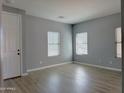 Bedroom with neutral walls, hard wood floors, and large windows at 4056 E Devon Dr, Gilbert, AZ 85296