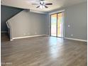 Spacious living room with sliding glass doors and stairs at 4056 E Devon Dr, Gilbert, AZ 85296