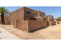 Two-story home with textured stucco exterior and a small walled front yard at 4218 S 46Th Pl, Phoenix, AZ 85040