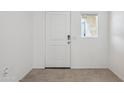 Bright entryway featuring white door, small window and neutral tile flooring at 5094 E Umber Rd, San Tan Valley, AZ 85143