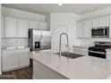 Modern kitchen with stainless steel appliances, white cabinets, and a large island at 5865 E Axle Ln, San Tan Valley, AZ 85140