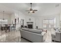 Open living room with bar seating, tile floors, and fireplace for a cozy atmosphere at 620 N Entrada St, Chandler, AZ 85226