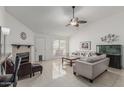 Bright living room featuring tile floors, a fireplace, and comfortable seating arrangements at 620 N Entrada St, Chandler, AZ 85226