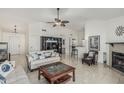 Spacious living room with tile flooring, a fireplace, and a ceiling fan for added comfort at 620 N Entrada St, Chandler, AZ 85226