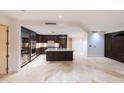 Gourmet kitchen with stainless steel appliances, custom cabinetry, and island at 7175 E Camelback Rd # 902, Scottsdale, AZ 85251