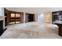 Bright living room with fireplace, balcony, and city views at 7175 E Camelback Rd # 902, Scottsdale, AZ 85251