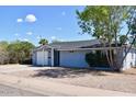 Charming single-story home featuring a well-maintained yard, fresh paint, and an attached one car garage at 7635 E Verde Ln, Scottsdale, AZ 85251