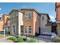 A view of the house with stucco and stone, and a cozy outdoor seating area at 7734 W Terri Lee Dr, Phoenix, AZ 85035