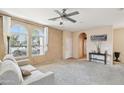 Bright and airy living room featuring neutral colors, large windows, and comfortable seating area at 7734 W Terri Lee Dr, Phoenix, AZ 85035