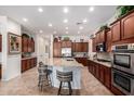 Spacious kitchen with a large island, granite countertops, and dark wood cabinetry at 800 W Sycamore Ct, Litchfield Park, AZ 85340
