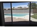View of the private backyard pool and landscaping from inside the home at 8716 E Holly St, Scottsdale, AZ 85257