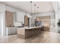 Spacious kitchen features a large island with seating, modern appliances, and elegant pendant lighting at 11140 W Prospector Dr, Queen Creek, AZ 85144