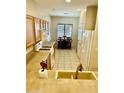 Traditional kitchen with tile flooring and modern appliances adjacent to the dining area at 13783 W Caribbean Ln, Surprise, AZ 85379