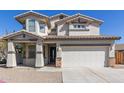 Inviting two-story home with a covered front porch and a two-car garage at 15324 W Windsor Ave, Goodyear, AZ 85395
