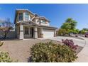 Beautiful two-story home with desert landscaping in the front yard at 15324 W Windsor Ave, Goodyear, AZ 85395