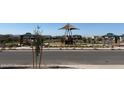 Community playground and park featuring picnic benches and lush landscaping at 17788 W Odeum Ln, Goodyear, AZ 85338