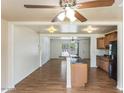 Bright open floor plan features wood floors, a ceiling fan and easy access to kitchen at 1836 W Las Palmaritas Dr, Phoenix, AZ 85021