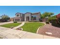 Charming home with a well-maintained lawn, mature trees, and a welcoming entrance at 2036 S Reseda Ct, Gilbert, AZ 85295