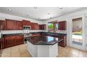 Gourmet kitchen featuring granite countertops, stainless steel appliances, and a center island at 2036 S Reseda Ct, Gilbert, AZ 85295