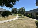 Landscaped courtyard between townhomes with green lawns and mature trees at 2051 W Elm St, Phoenix, AZ 85015