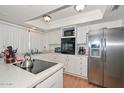 Well-lit kitchen featuring white cabinets, stainless steel refrigerator, and modern appliances at 2051 W Elm St, Phoenix, AZ 85015