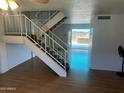 Open floorplan with wood flooring and staircase leading to the second level at 2051 W Elm St, Phoenix, AZ 85015
