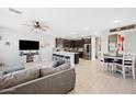 Open-concept kitchen featuring dark cabinetry, white countertops, and modern stainless-steel appliances at 20812 W Legend Trl, Buckeye, AZ 85396