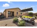 Cozy backyard featuring desert landscaping, artificial turf, and comfortable lounge seating at 22560 E Rosa Rd, Queen Creek, AZ 85142