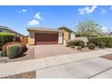 Charming single-story home with a brick driveway, well-maintained landscaping, and an attached garage at 22560 E Rosa Rd, Queen Creek, AZ 85142