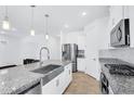 Bright kitchen features granite countertops, stainless steel appliances, and modern fixtures at 22560 E Rosa Rd, Queen Creek, AZ 85142
