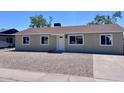 Charming single-story home with freshly painted exterior, updated windows, gravel yard, and manicured landscaping at 3049 W Dahlia Dr, Phoenix, AZ 85029