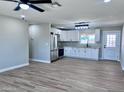 Open kitchen and living area featuring tile floors, modern appliances, quartz counters, white cabinets, and an eat-in space at 3049 W Dahlia Dr, Phoenix, AZ 85029