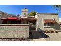 Charming home with stucco, a red awning, lovely landscaping and a private patio area at 3535 W Monte Cristo Ave # 129, Phoenix, AZ 85053