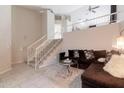 Bright living room with two-story ceilings, white railings and a large sectional sofa at 3755 E Broadway Rd # 36, Mesa, AZ 85206