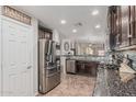 Modern kitchen featuring stainless steel appliances, granite countertops, and ample cabinet space at 3915 S 186Th Ln, Goodyear, AZ 85338