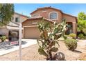 Inviting two-story home features desert landscaping and a prominent saguaro cactus at 4034 E Mine Shaft Rd, San Tan Valley, AZ 85143