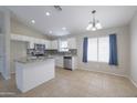 Well-lit kitchen with stainless steel appliances and tiled floors adjacent to the breakfast nook at 41388 W Hopper Dr, Maricopa, AZ 85138