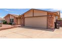 A single-story home with a two car garage and desert landscaping at 4245 E Yawepe St, Phoenix, AZ 85044